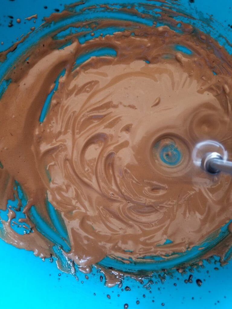 the whipped coffee is almost done it has tripled in size by whipping it with the beaters