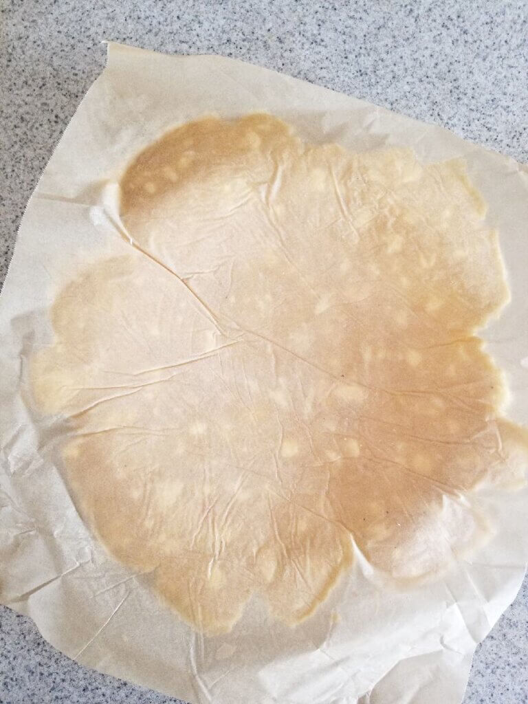transferring the almond flour pie crust to the pie dish