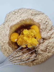 almond flour pumpkin muffin batter in a mixing bowl