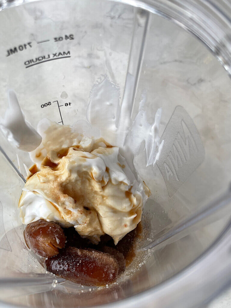 ingredients for healthy date caramel in a blender before blending