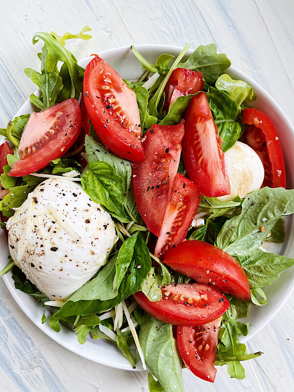 Arugula caprese salad with burrata cheese and balsamic