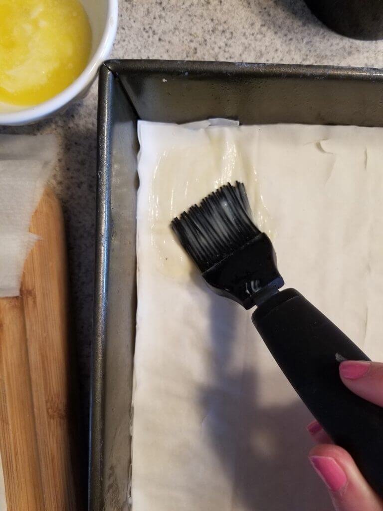 brushing phyllo dough with melted butter