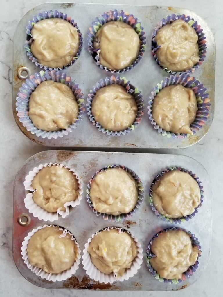 muffin tins filled with banana muffin batter before baking
