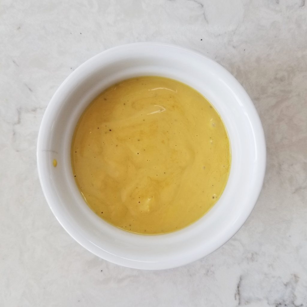 caesar salad dressing in a white ramekin