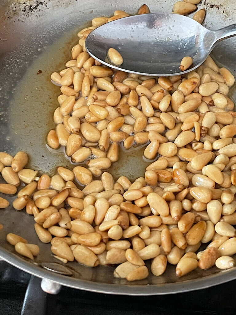 toasted pine nuts in a small pan