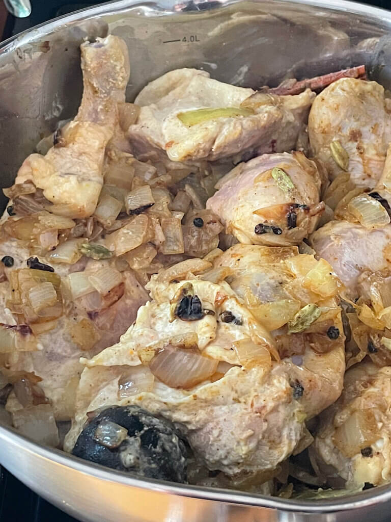 added marinated chicken with the onions and spices in the pot