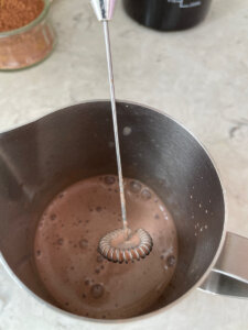 mixing chocolate cold foam for iced coffee