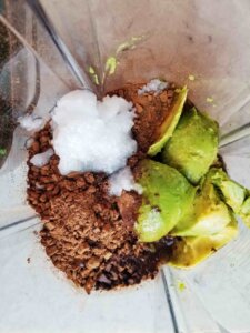 chocolate avocado frosting ingredients in a blender