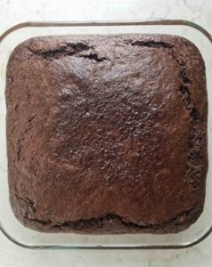 chocolate zucchini cake in a glass baking dish after baking