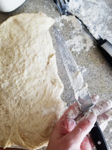 Dough for the ciabatta rolls on a floured surface