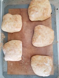 ciabatta rolls on a baking sheet after baking