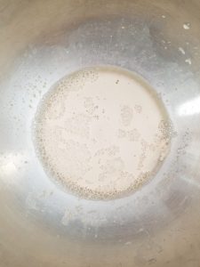 stainless steel bowl with foamy activated yeast