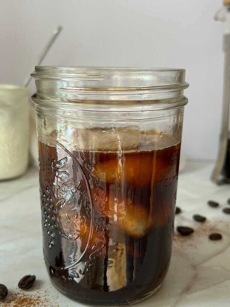 cold brew coffee in a mason jar with ice cubes