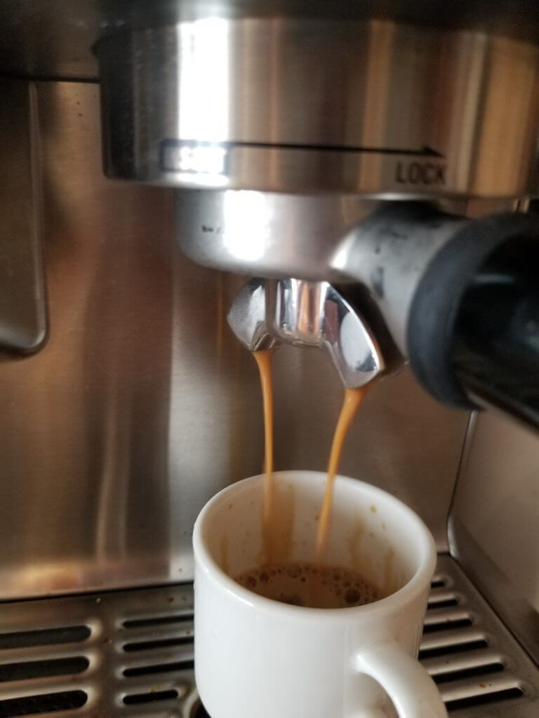 close up of a double shot of espresso coming out of the espresso maker