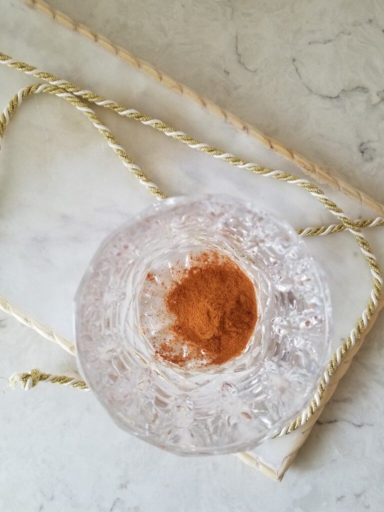 golden milk latte mix in the bottom of a glass