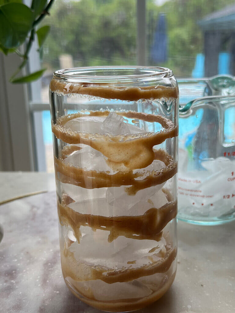 caramel swirl on the side of a glass with ice cubes