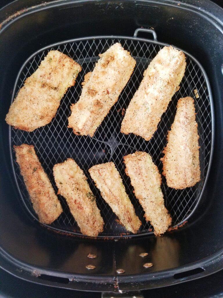 zucchini fries in air fryer basket after cooking