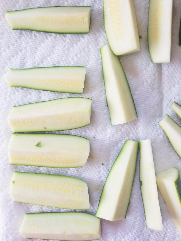 zucchini slices on a paper towel