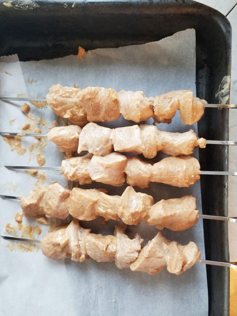 chicken on metal skewers before cooking