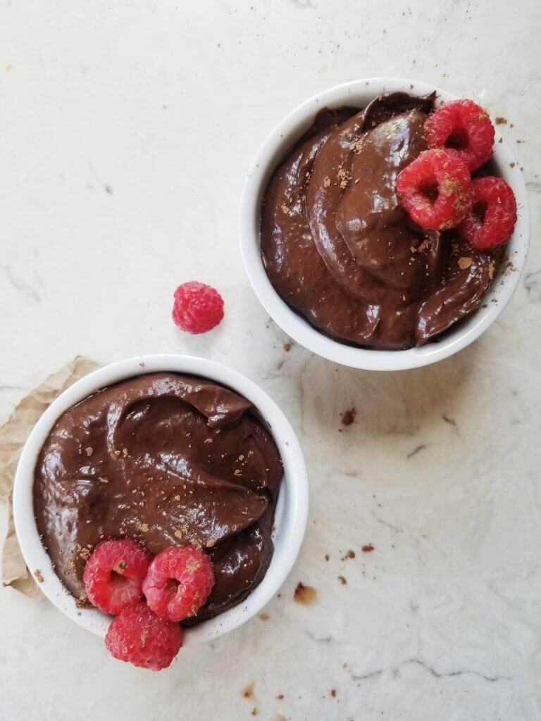 healthy chocolate avocado pudding with raspberries