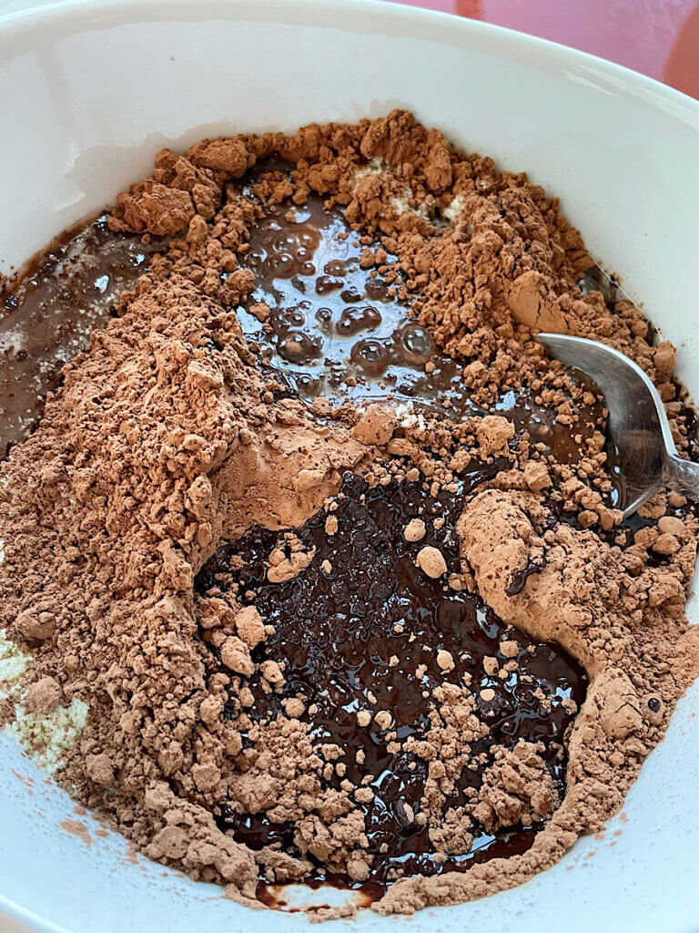 cacao powder almond flour and melted coconut oil in a bowl