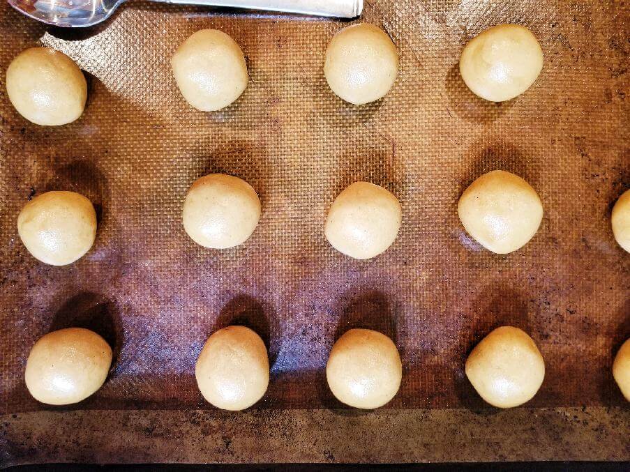 peanut butter balls on a nonstick cooking sheet