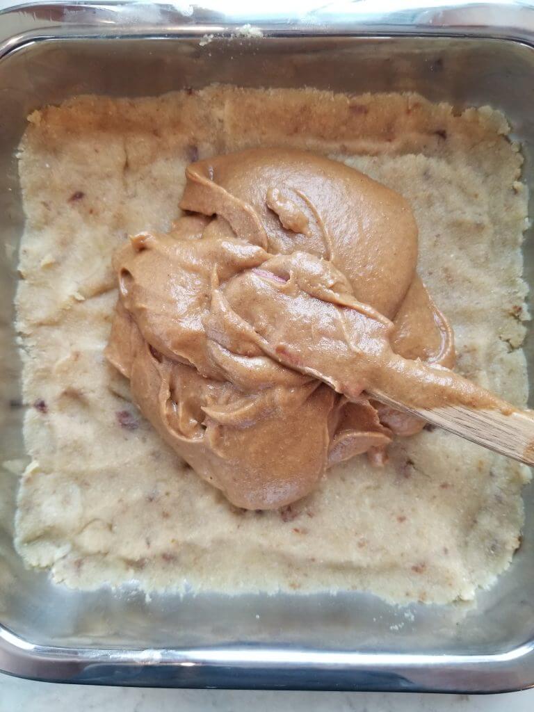adding the Twix date caramel on top of the no bake cookie base