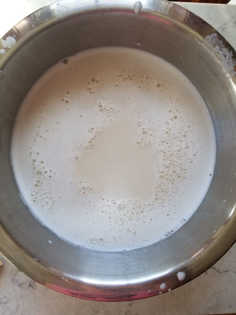 fresh almond milk in a stainless steel bowl