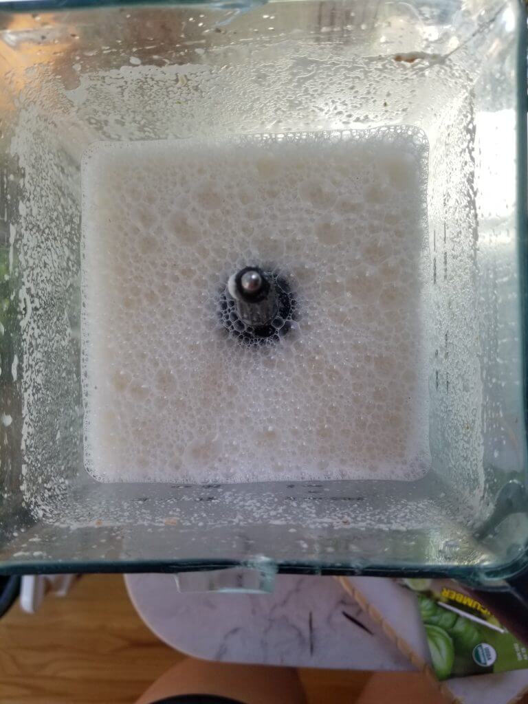 almond milk foam in a blender