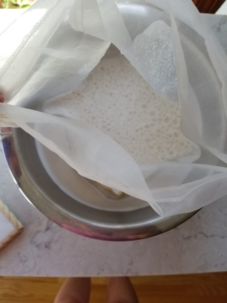 almond milk in a nut milk bag