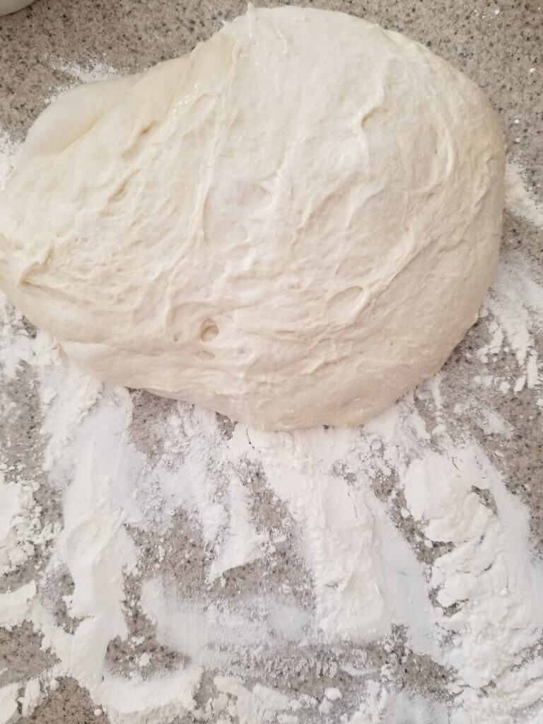 homemade ciabatta bread dough on a floured counter