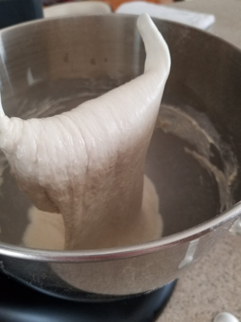 hook attachment with finished ciabatta bread dough coming off it