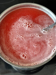 homemade gummies with gelatin mixing over the stove