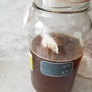 black tea in a large glass jar