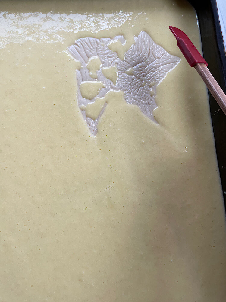 adding the cream on the basbousa