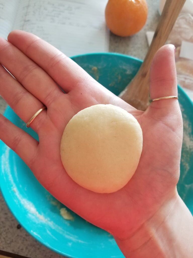 pressed healthy sugar cookie dough in hand