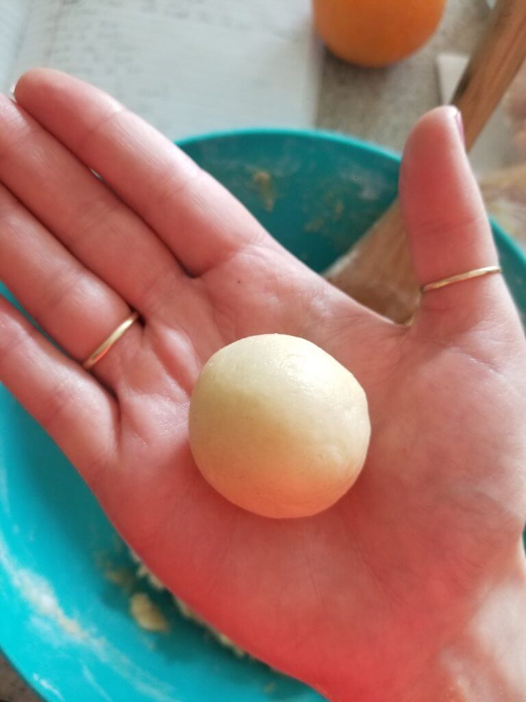 ball of healthy sugar cookie dough in hand