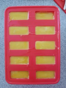 mango yogurt popsicles in molds