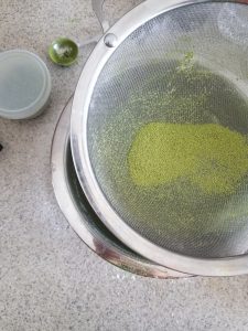 sifting matcha and almond flour