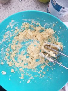 whipping the butter together for the mango frosting