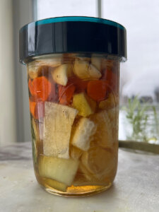 honey fermenting with garlic onions and herbs
