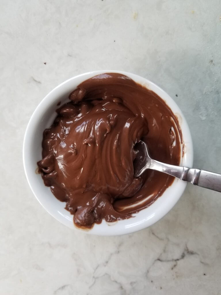 melted dark chocolate chips to dip reese's cookie dough balls in