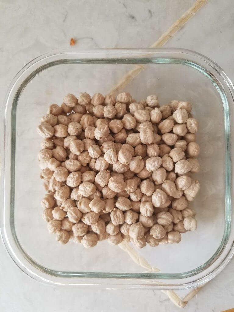 dried chickpeas in a dish before they are soaked overnight