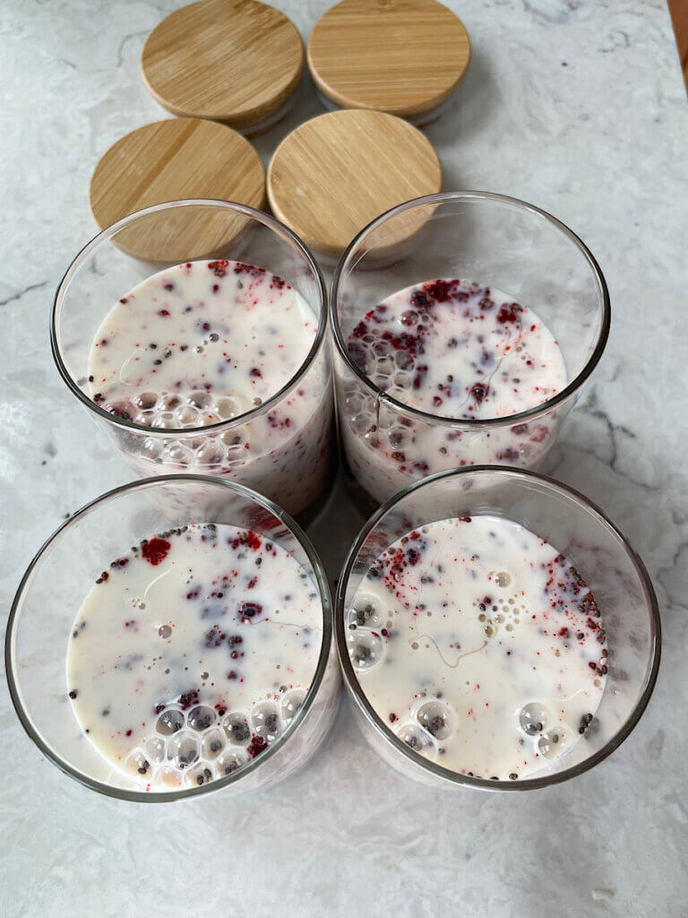 pink chia pudding in jars before mixing with milk