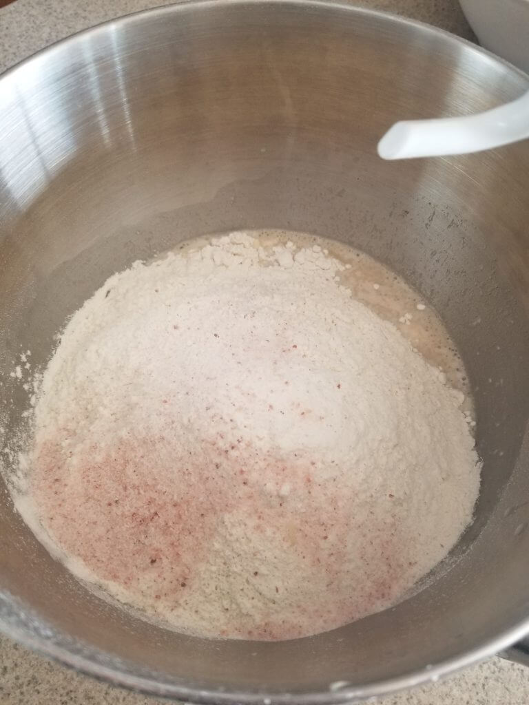 adding the flour to the mixing bowl