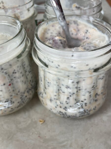 Raspberry cheesecake overnight oats recipe in glass jars