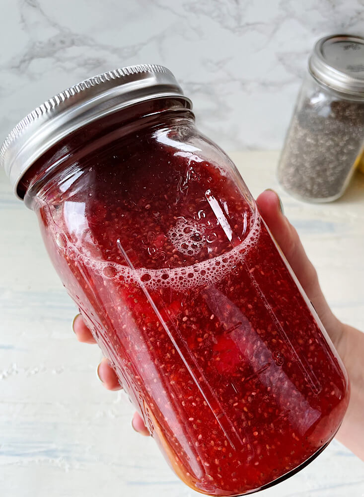 red raspberry chia seed water recipe with lemon in a mason jar