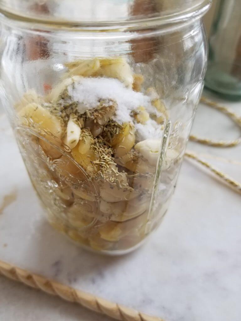 fava beans in a mason jar with rosemary and sea salt sprinkled on top