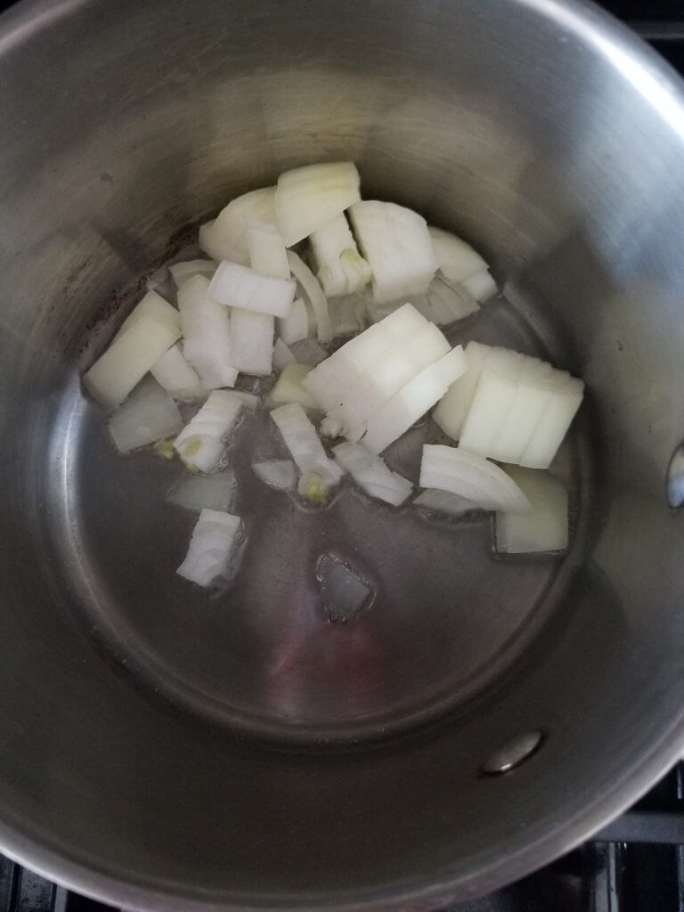 chopped onions in a pan with oil