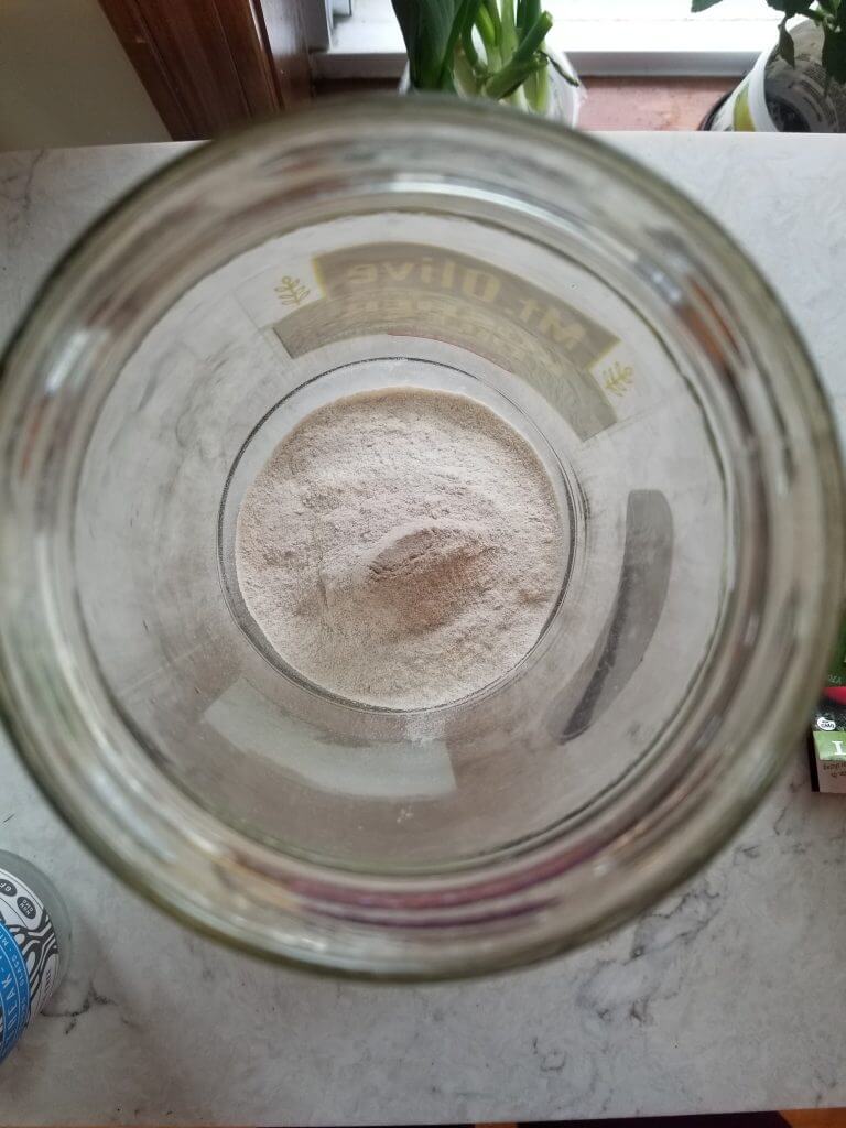 big glass jar with wheat flour in it